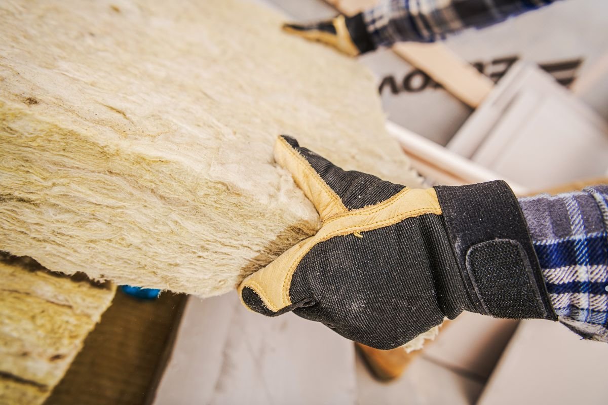 A person holds a piece of insulation material, showcasing the product used in insulation services.